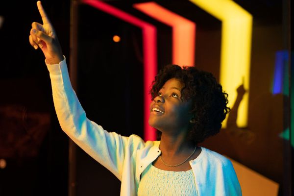 Jente som peker mot en lysskilde